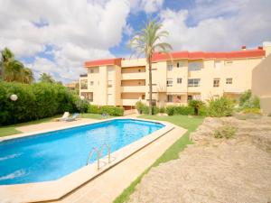 a swimming pool in front of a building at Apartment Montañar in Jávea