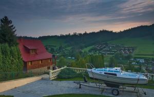 a boat on a trailer in front of a house at Willa Wuja Sama in Zawóz
