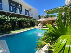 a swimming pool in the backyard of a house at Hotel Junior in Caazapá