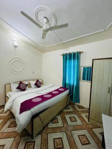 a bedroom with a bed with a ceiling fan at The Hidden Cove in Bhīm Tāl +70 photos