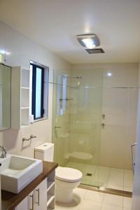a bathroom with a toilet and a glass shower at Seven On Myrtle at Hat Head - Bring your own linen. in Hat Head +11 photos