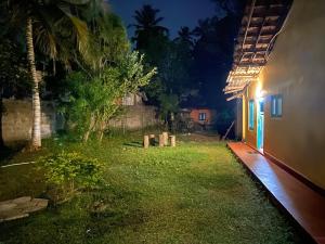 a yard of a house at night with a building at NimSri Villa by Prazzventures in Mirissa +24 photos