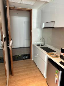 a kitchen with a sink and a counter top at HomeAwayFromHome in Phuket