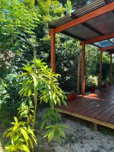 a wooden deck with a pavilion in a garden at Íntimo in Salinas 
