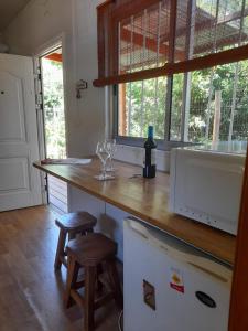 a kitchen with a counter with two wine glasses on it at Íntimo in Salinas  +8 photos