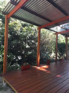 a wooden pergola with potted plants on a deck at Íntimo in Salinas +8 photos