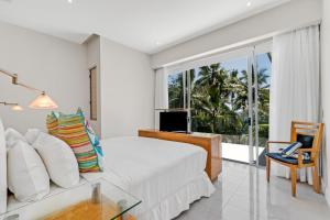 a bedroom with a bed and a large window at Belle Escapes Daydream at Drift Beachfront in Palm Cove