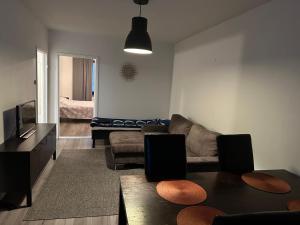 a living room with a couch and a television at StyleStudio 1BR in Kemi centrum in Kemi