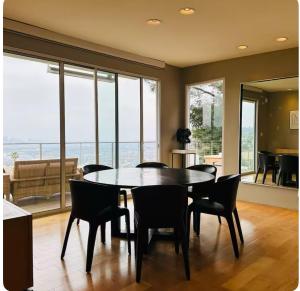 a dining room with a table and chairs at Secluded Luxury Hollywood Hills Retreat in Los Angeles
