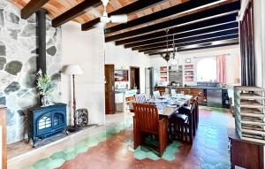 a kitchen and dining room with a table and a fireplace at 4 Bedroom Stunning Home In Porreres in Porreres