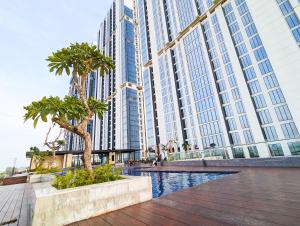 a large building with palm trees in front of it at Lovina 806 at Pollux Meisterstadt in Batam Center