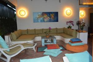 a living room with a couch and a table at Villa Raquel in Seminyak
