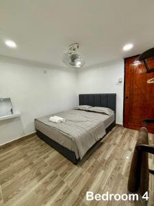 a bedroom with a bed and a wooden floor at Aster Homestay Telok Panglima Garang in Teluk Panglima Garang