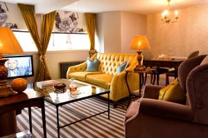 a living room with a couch and a table at The Torridon in Torridon