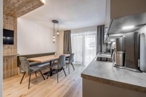 a kitchen and dining room with a table and chairs at Apart Natur in Sölden
