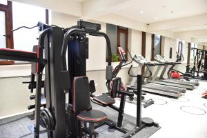 a gym with a row of tread machines at Beijing Tiananmen Wangfujing Ruibeting Apartment Hotel in Beijing