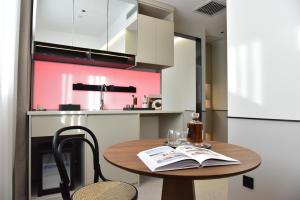 a kitchen with a wooden table with a book on it at Beijing Tiananmen Wangfujing Ruibeting Apartment Hotel in Beijing