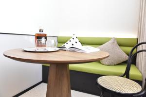 a table with a bottle of wine and a book at Beijing Tiananmen Wangfujing Ruibeting Apartment Hotel in Beijing