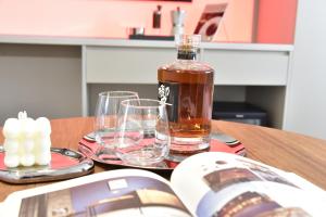 a bottle of alcohol sitting on a table with glasses at Beijing Tiananmen Wangfujing Ruibeting Apartment Hotel in Beijing