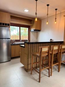 a kitchen with wooden cabinets and a stainless steel refrigerator at Flat Sollare in Marau