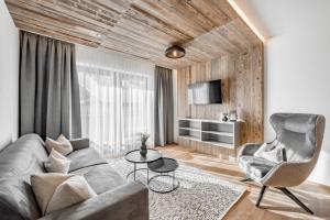 a living room with a couch and a chair at Apart Natur in Sölden