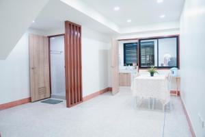 a dining room with a table and a window at Be House in Hat Yai