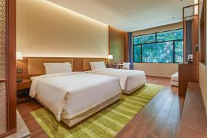 Voodi või voodid majutusasutuse Guangdong Hot Spring Hotel toas
