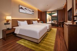 Voodi või voodid majutusasutuse Guangdong Hot Spring Hotel toas