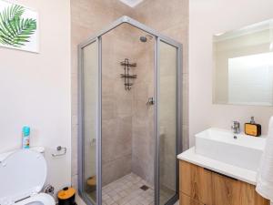 a bathroom with a shower and a sink at Sunset Haven in Midrand
