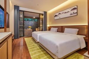Voodi või voodid majutusasutuse Guangdong Hot Spring Hotel toas