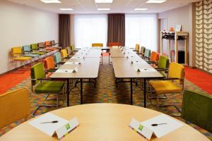 a classroom with tables and chairs in a room at ibis Styles Chaumont Centre Gare in Chaumont