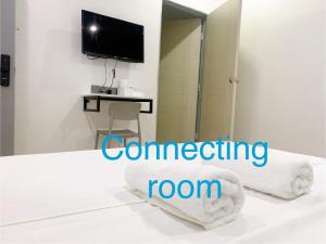 Postel nebo postele na pokoji v ubytování One Stop Hotel Ipoh