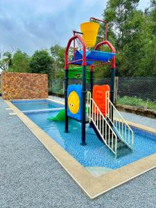 a playground with a slide in a pool at Melur Inn, Tok Jembal in Kampong Tanjong Gelam