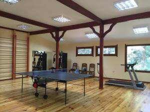 a ping pong table in a room with a gym at Хотел "Калина" in Borovets