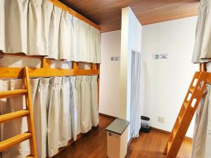 a room with two bunk beds and a ladder at Lucky House Niseko in Kutchan
