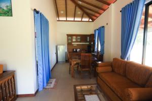 a living room with a couch and a table at Mango Garden Dambulla in Dambulla