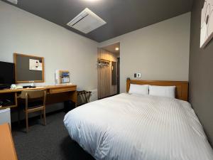 Postel nebo postele na pokoji v ubytování Hotel Route-Inn Jouetsu