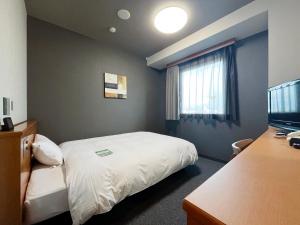 Postel nebo postele na pokoji v ubytování Hotel Route-Inn Jouetsu