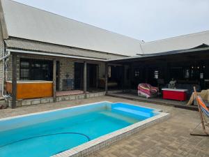 a large blue swimming pool next to a building at 6 Segal Close in Velddrif