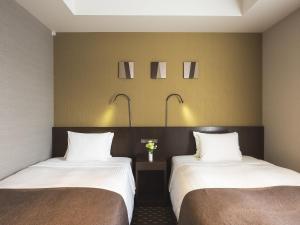 Postel nebo postele na pokoji v ubytování Akihabara Washington Hotel