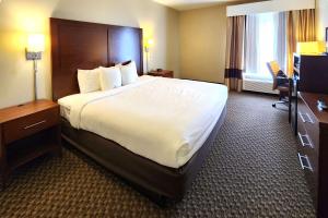 a hotel room with a large bed and a desk at Comfort Inn & Suites Mount Pocono in Mount Pocono +71 photos