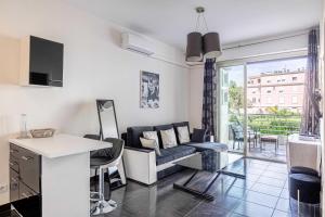 a living room with a couch and a table at Welcoming Apartment with parking - Croisette in Cannes