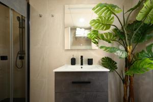 a bathroom with a sink and a mirror and a plant at La Paz by 10toSea in Fuengirola +56 photos