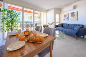 a dining room with a table with food on it at La Paz by 10toSea in Fuengirola