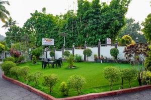 a garden with horses in the middle of a lawn at Athirappilly Ambady Resort in Athirappilly