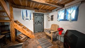 a living room with a large door and a chair at Casa Fierarului in Şinteu