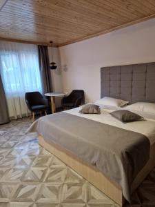 a bedroom with a large bed with two pillows on it at Casa Anda in Pucioasa