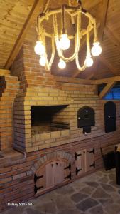 a brick wall with a fireplace in a room at Casa Anda in Pucioasa +37 photos