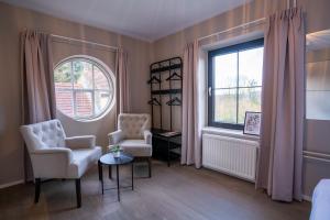 a living room with two chairs and a window at LouLou in Berg en Terblijt