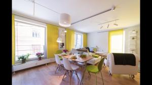 a dining room and living room with a table and chairs at Bright Home in Tallinn +12 photos